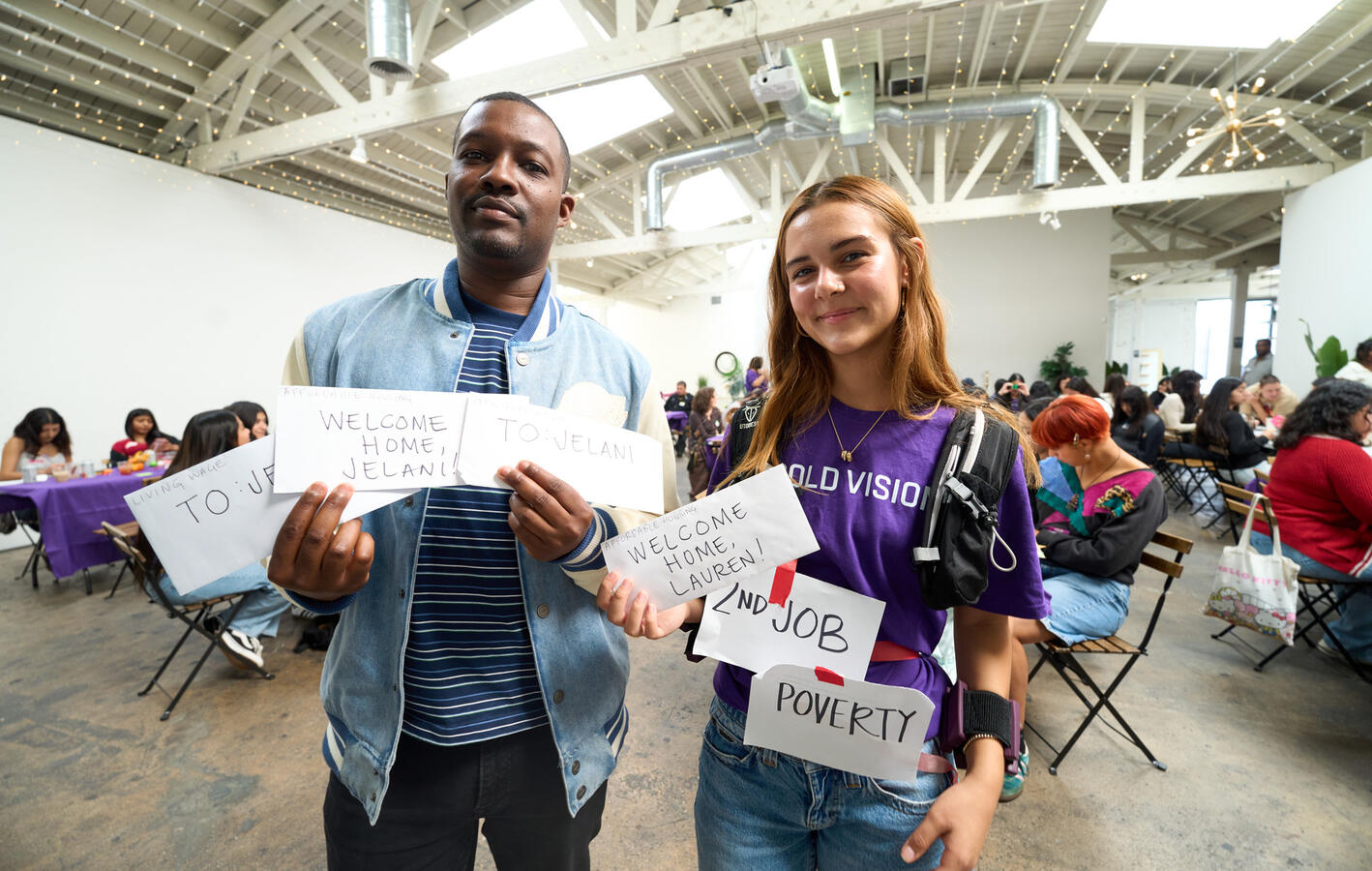 Presenting Summit Findings Two presenters hold up printed material while addressing the October Youth Summit.