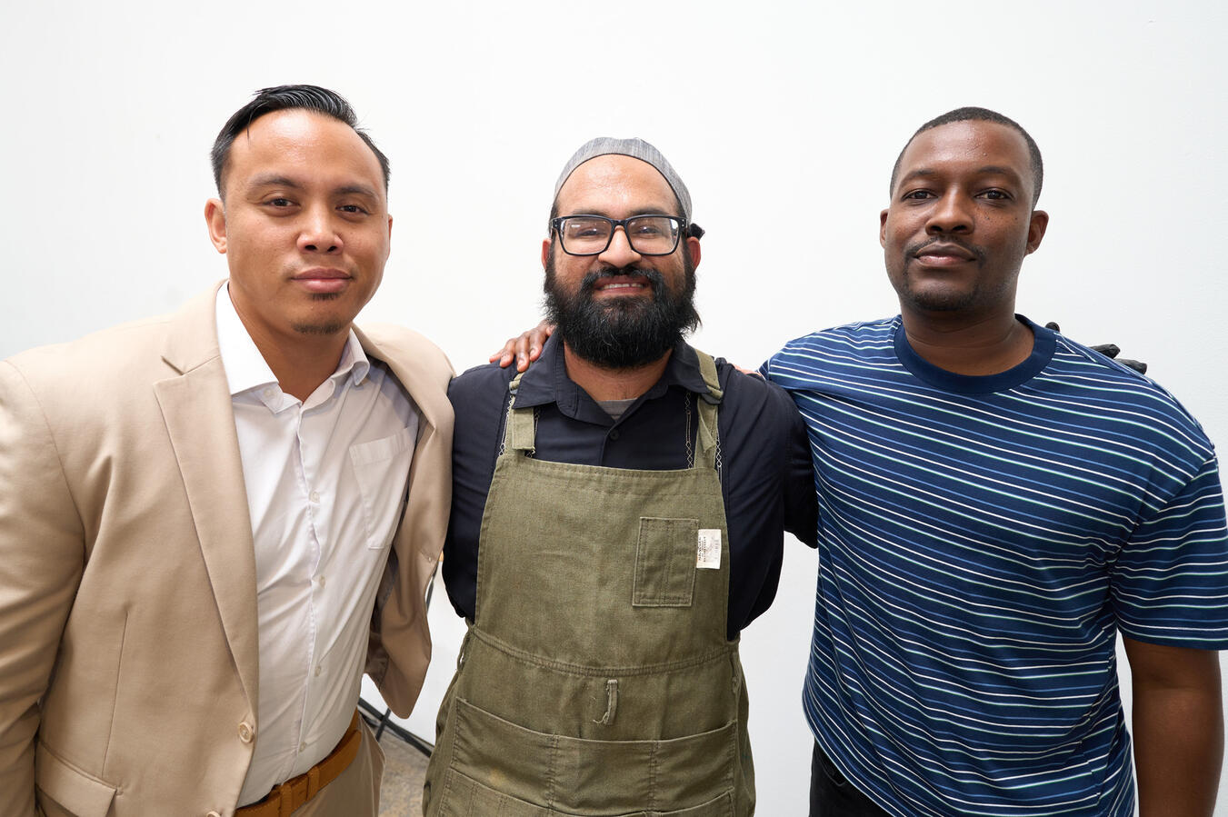 Bold Vision Staff Portrait Three men pose together at the October Youth Summit.