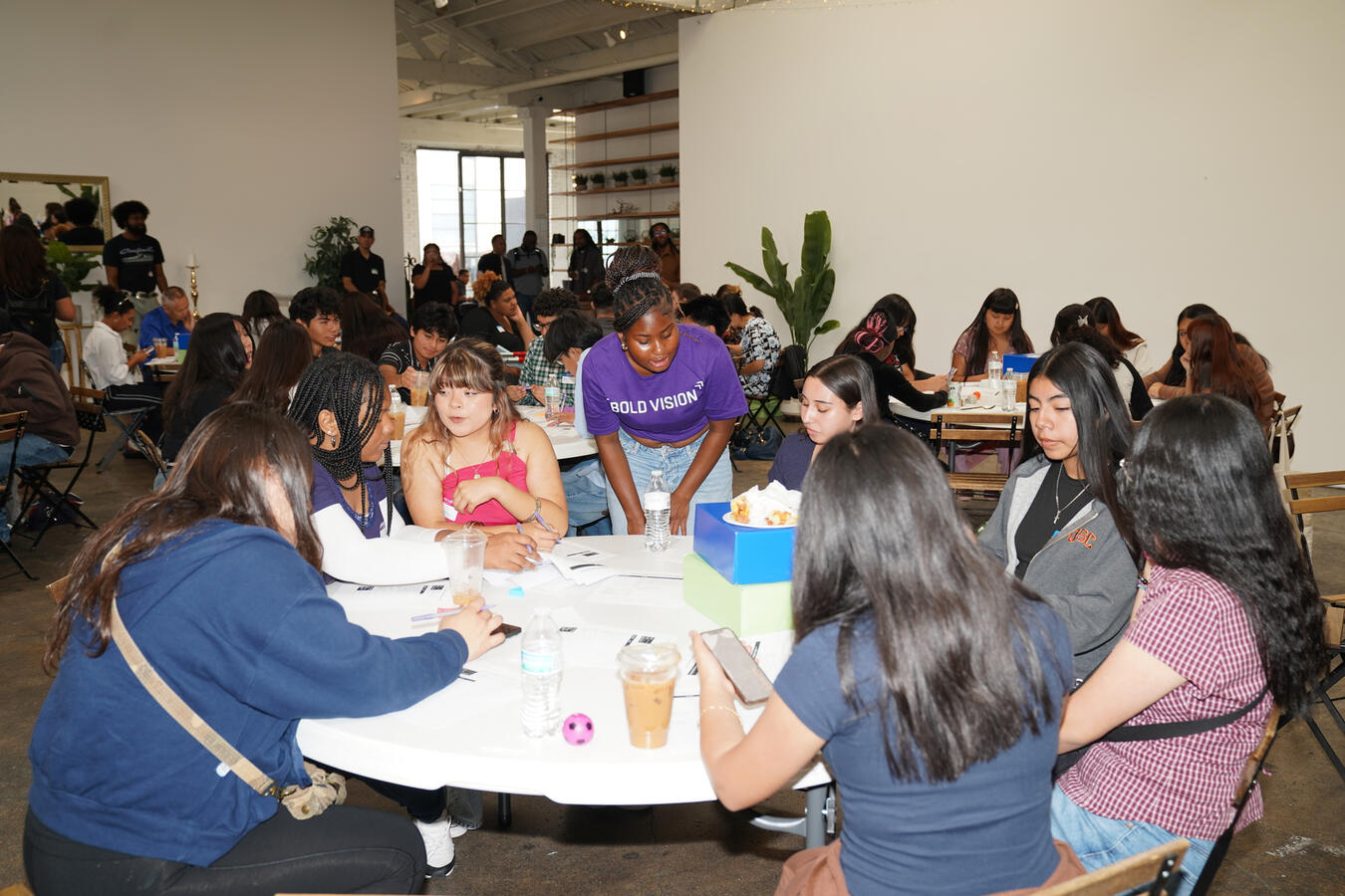 Attendees gather around a table for a workshop discussion at the Bold Vision Youth Summit.