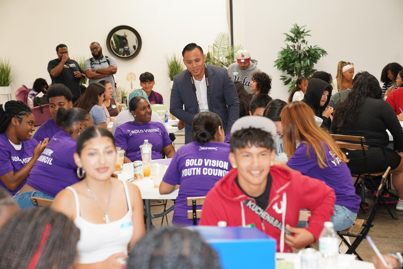 Youth Summit attendees sit together in conversation at a table.