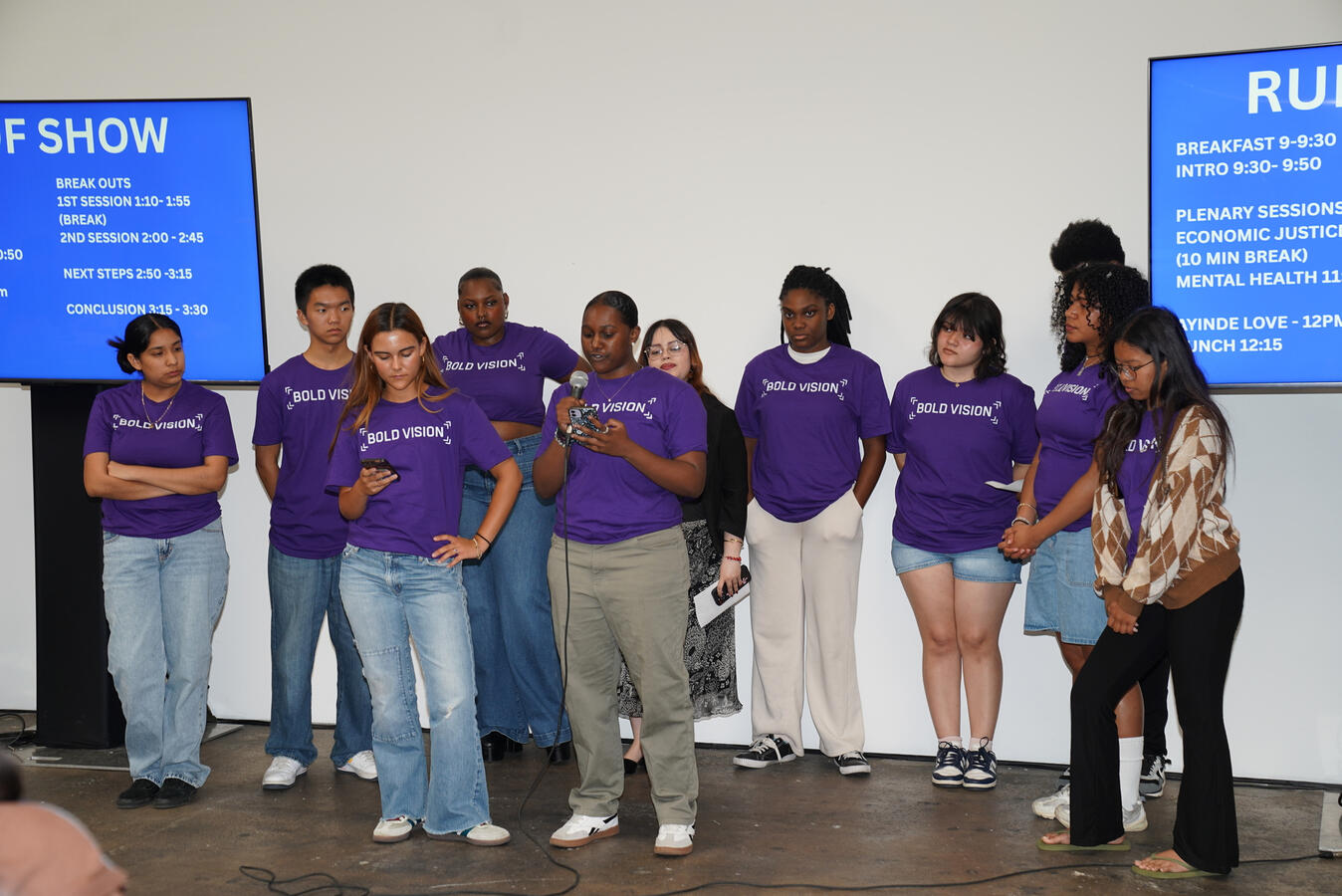 Youth Council Presenting at the Summit Bold Vision Youth Council members stand together on stage during a summit presentation.