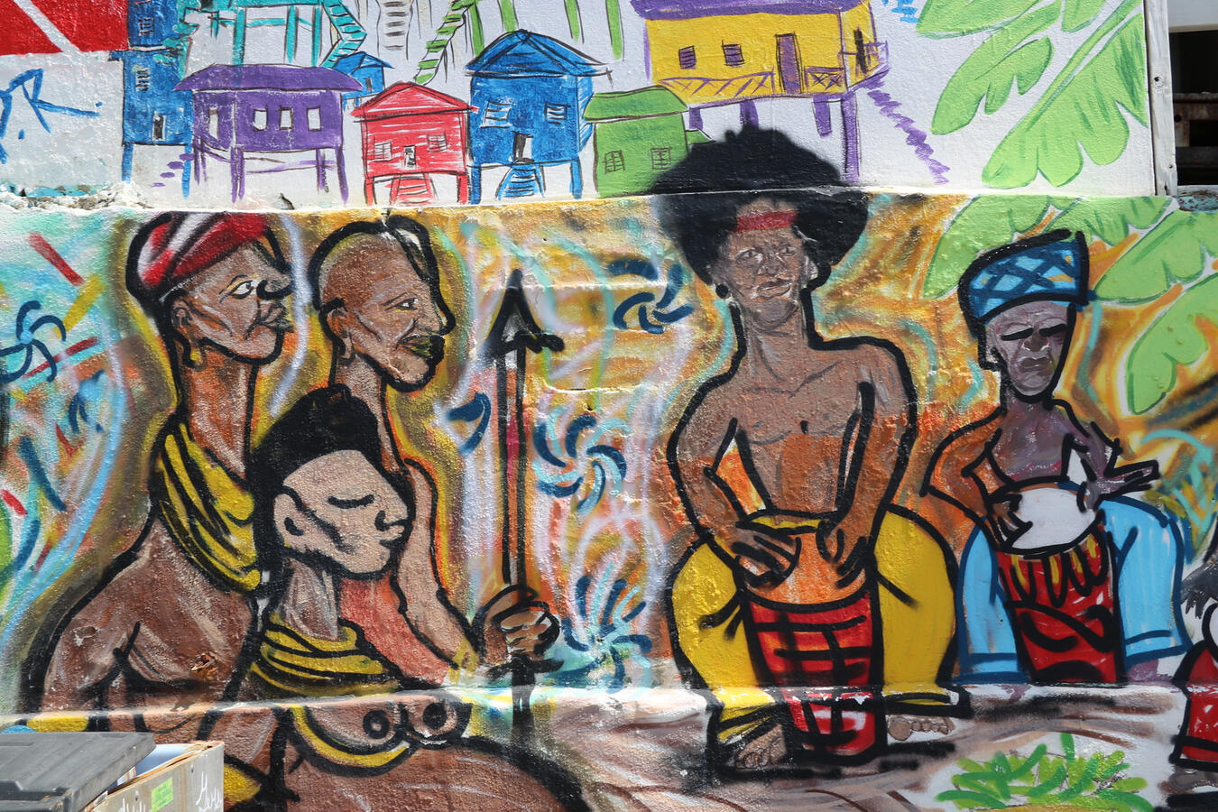 A colorful street mural in San Juan depicts Afro-Puerto Rican figures with drums and spears.