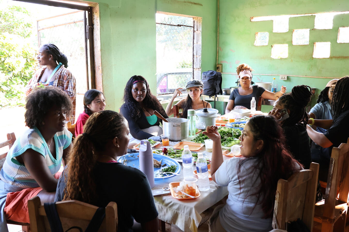 Shared Meal with the Delegation Fellows share a meal together at a long table inside a home in Cuba.