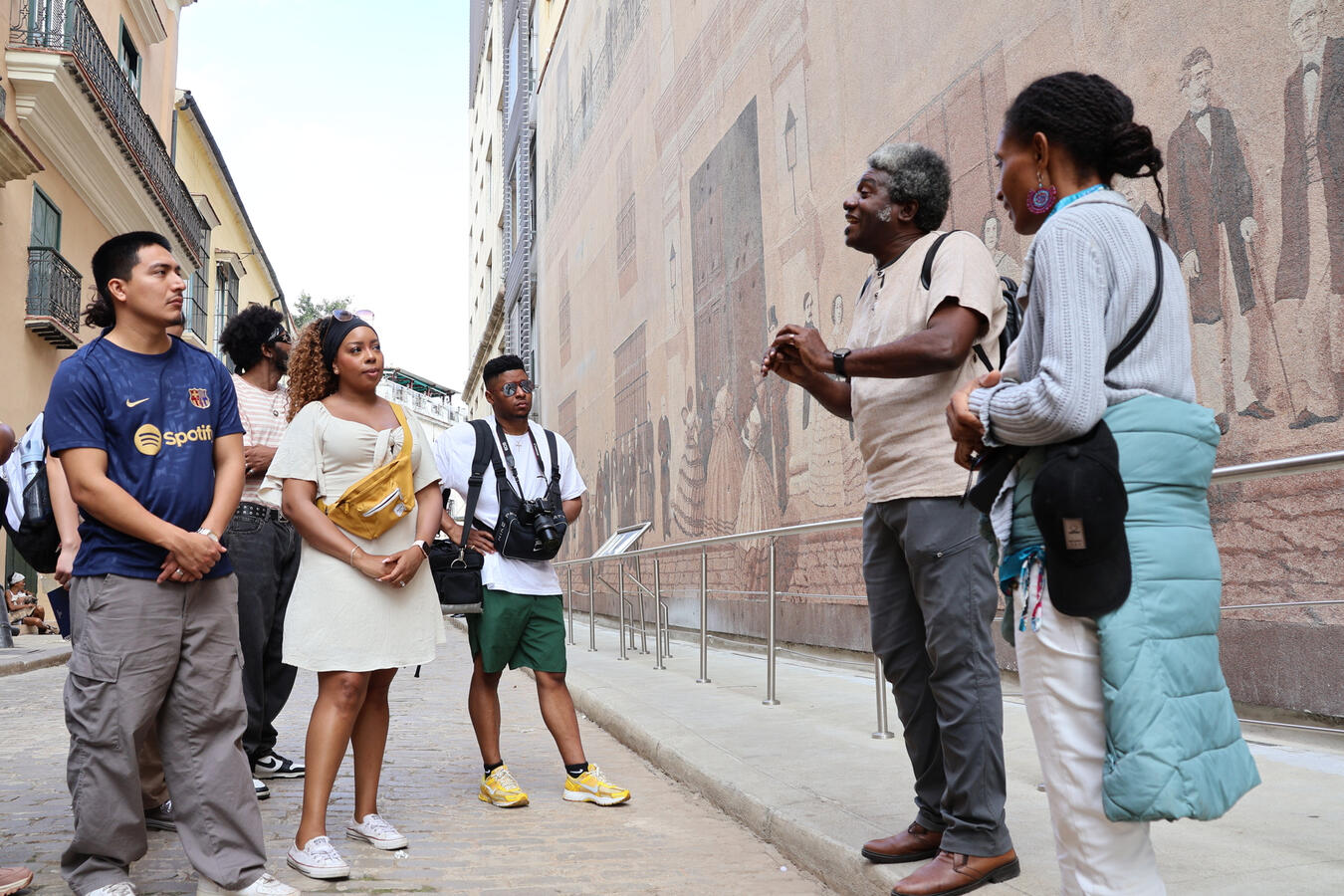 Delegation members speak with a local resident on a street in Havana.