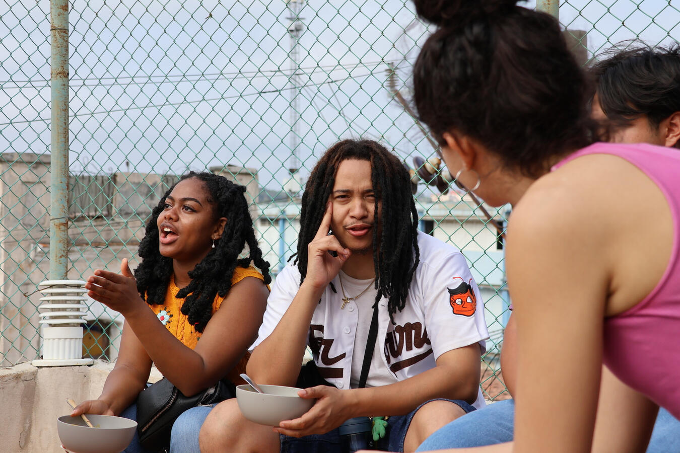 Three delegation members sit close together in conversation.