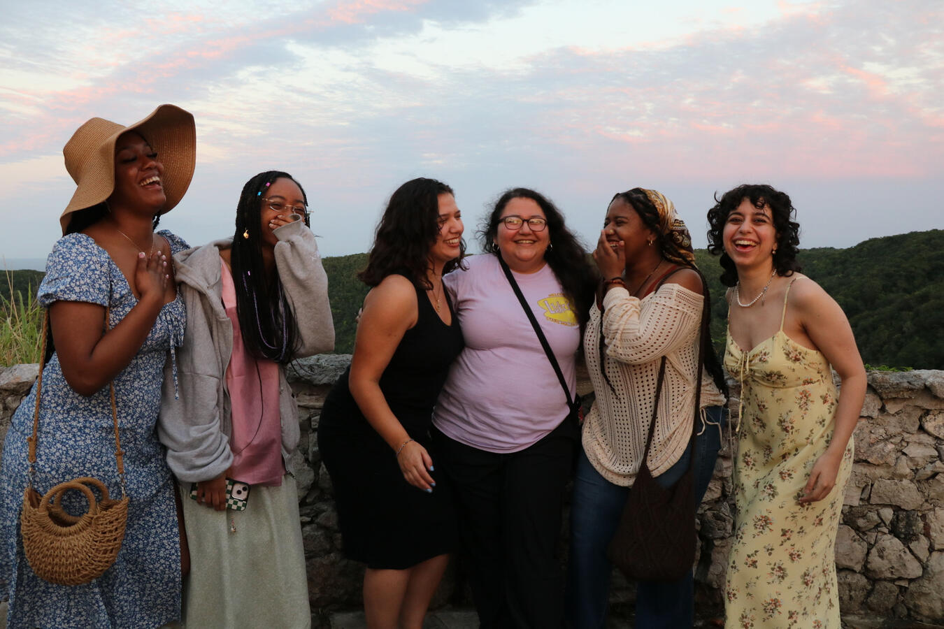 Group Portrait at Sunset Five women pose together outdoors at sunset during the Cuba fellowship.