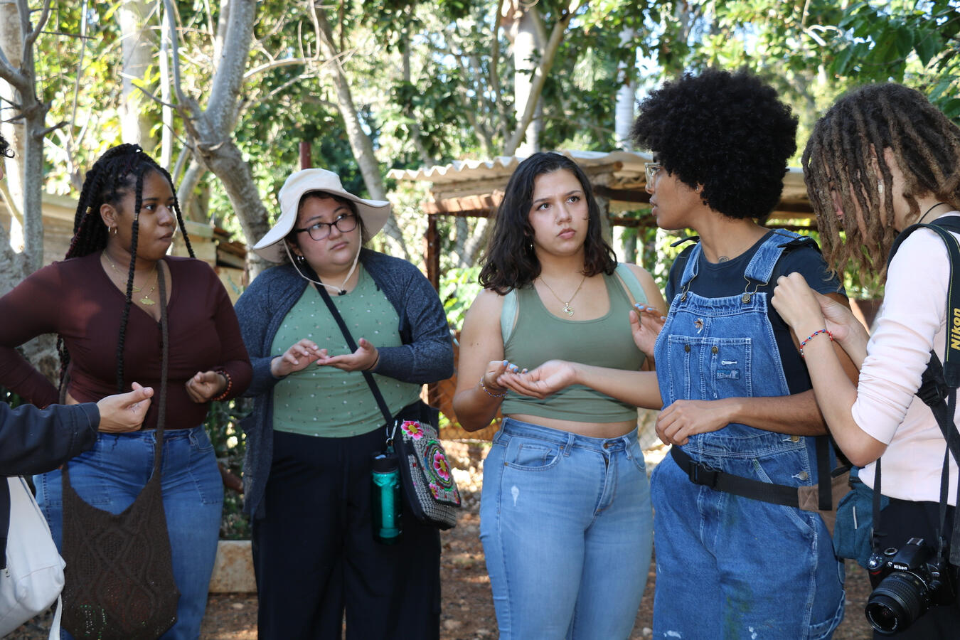 Fellows in Conversation A group of young delegation members talk together outdoors during the Cuba fellowship.