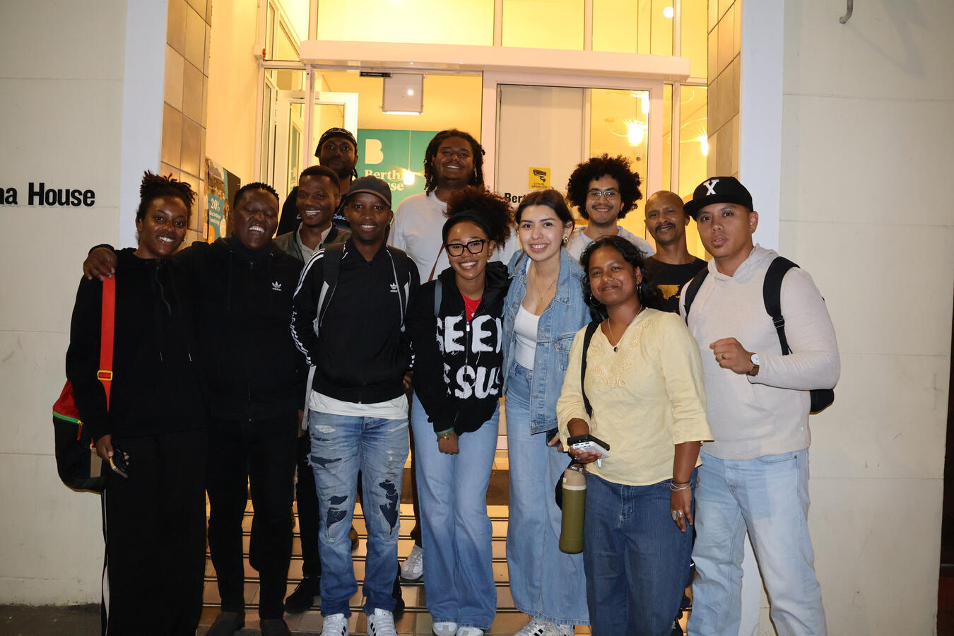 The delegation gathers indoors near the entrance of a cultural or historical site in Cape Town.