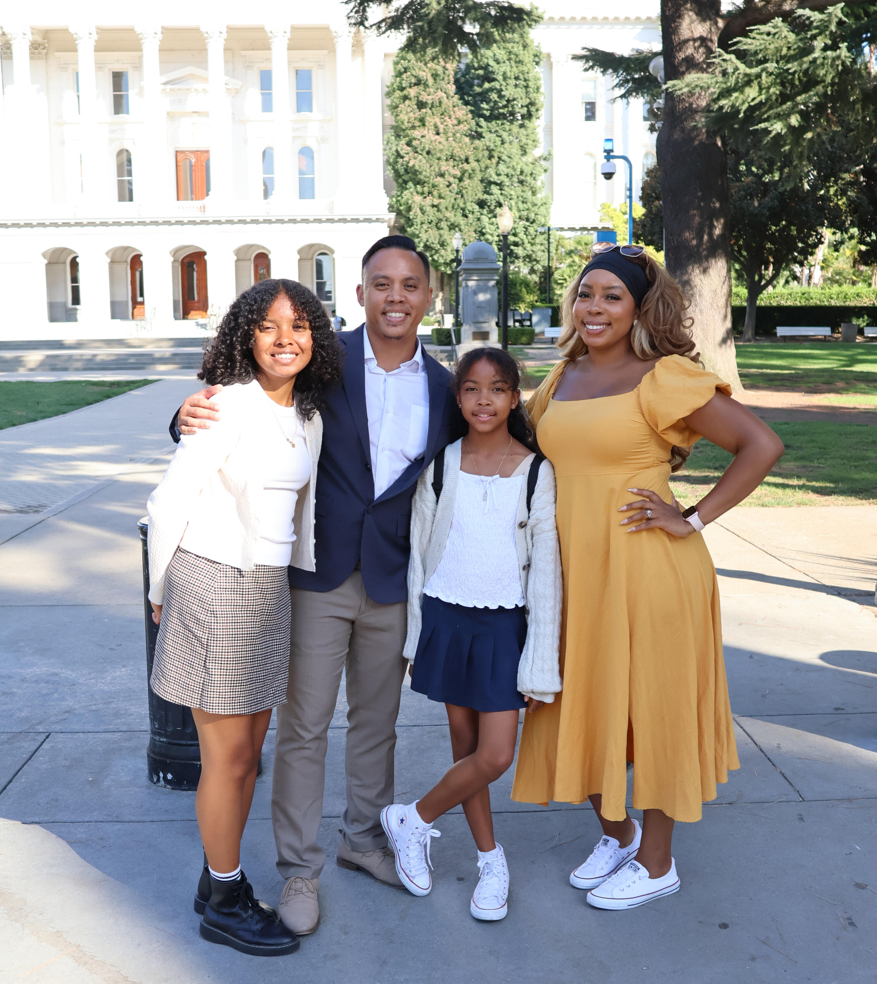 Gabriel Regalado stands with his wife and daughter outside the California State Capitol.